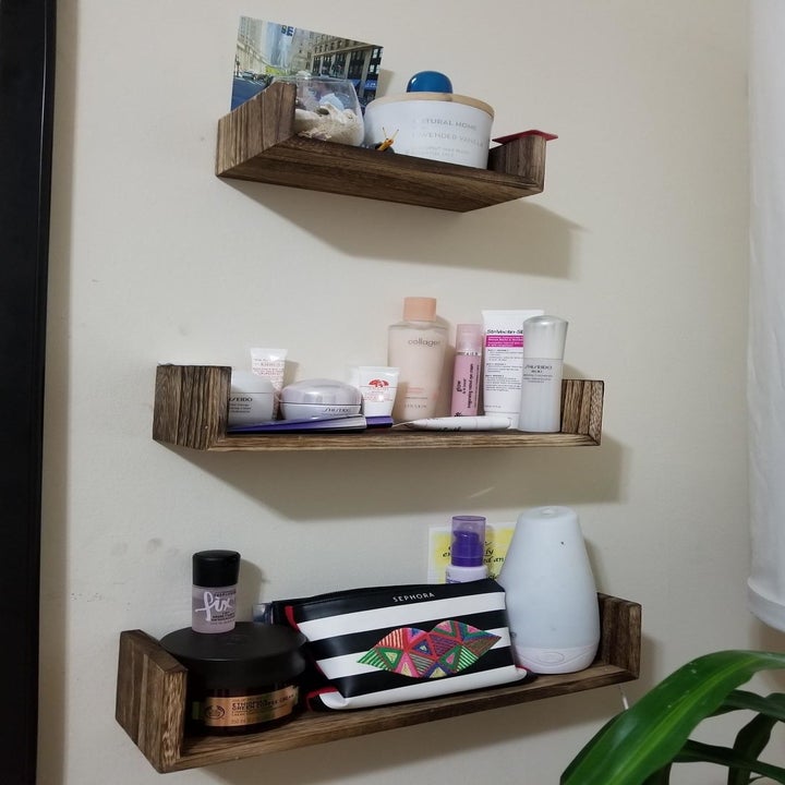 reviewer photo showing three shelves used for makeup products