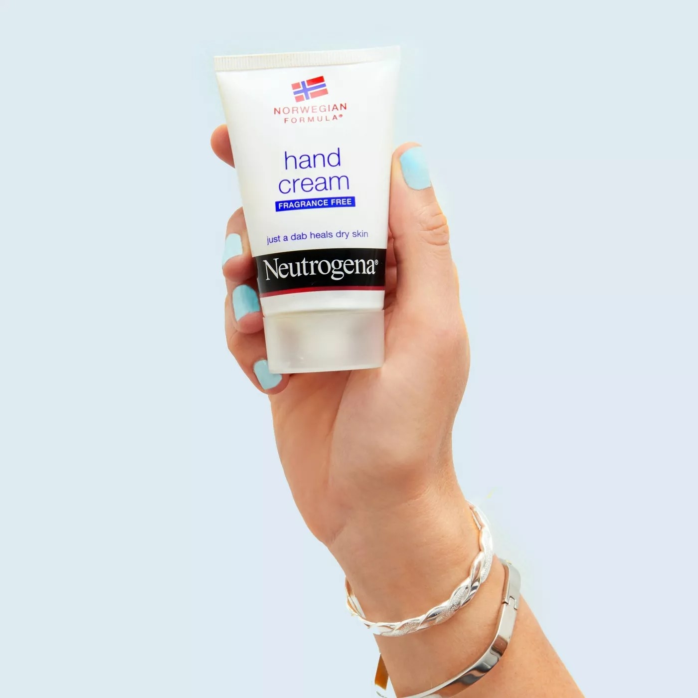 A hand holding up Neutrogena&#x27;s Norwegian formula hand cream