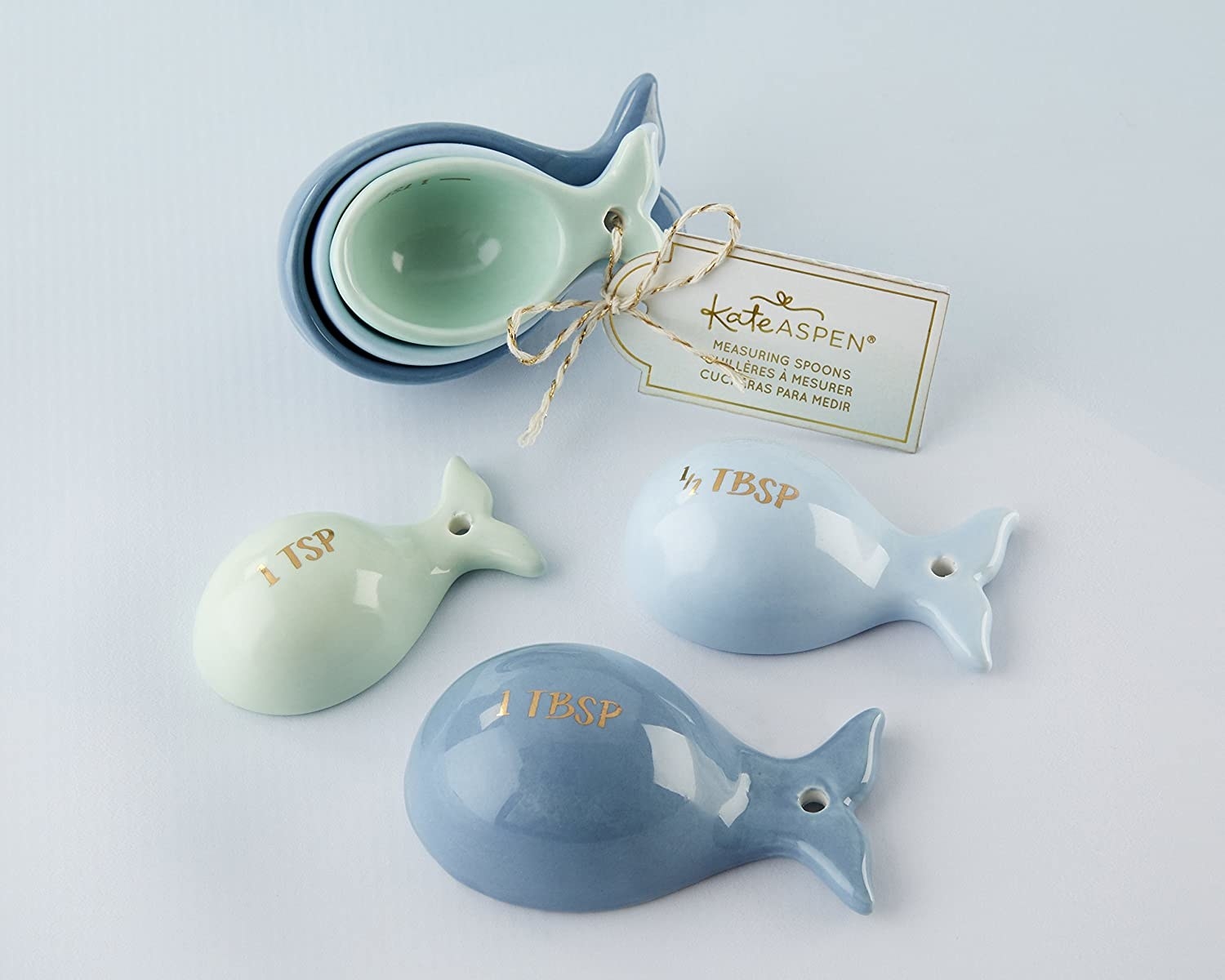 A trio of whale-shaped measuring spoons with gold foil labelling