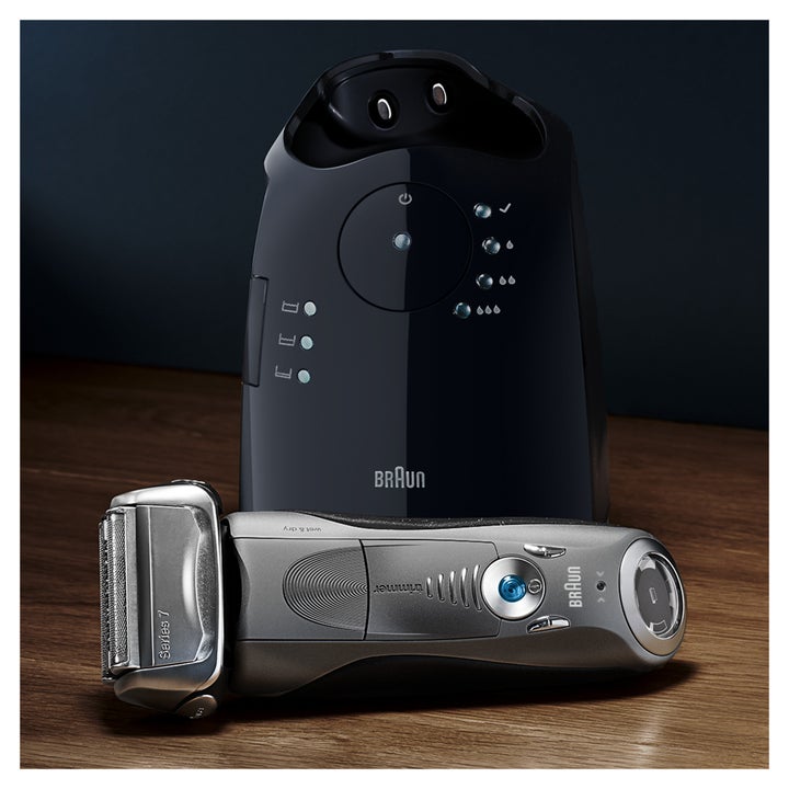 braun electric shaver with a clean docking station behind it