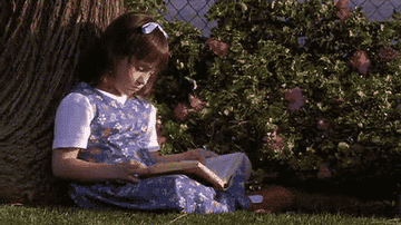 Matilda flipping through a book