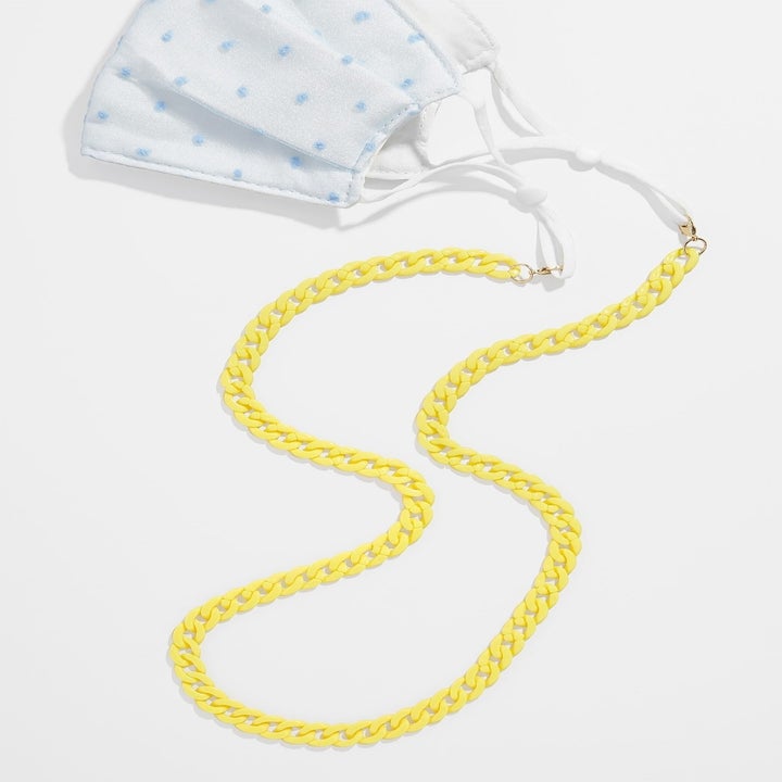 Yellow chain attached to face mask ear loops
