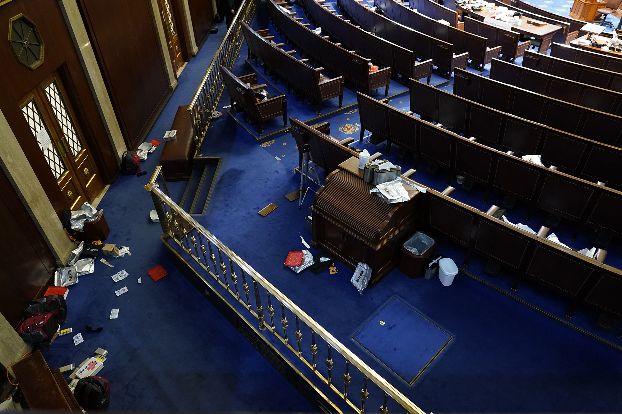 Litter and gas mask wrappers are strewn on the floor