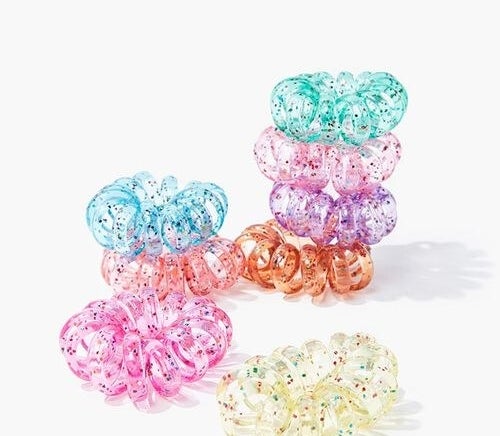 spiraled plastic hairties in clear, pink, orange, purple, and blue with multicolored glitter 