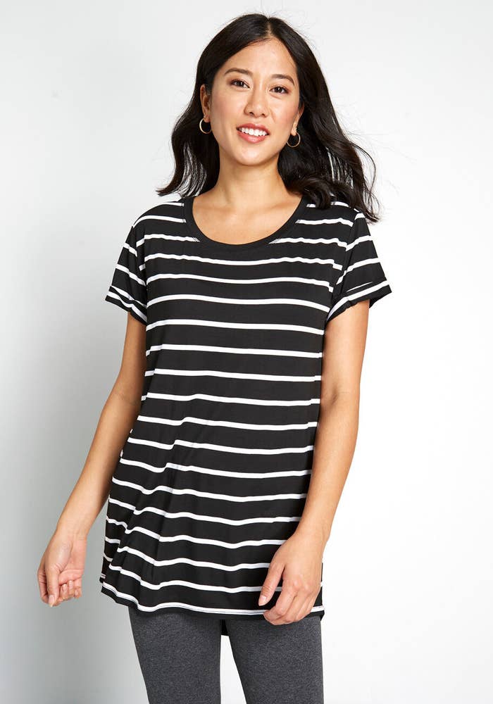 Model in the black and white striped tunic with gray leggings