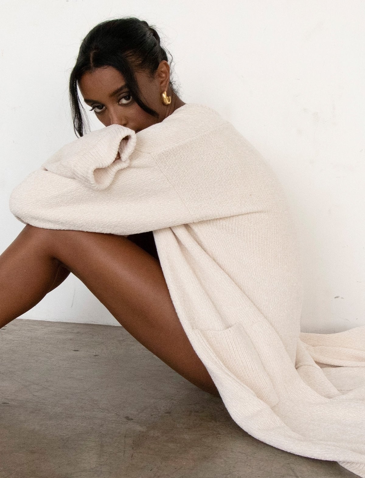 model wearing the white slouchy sweater