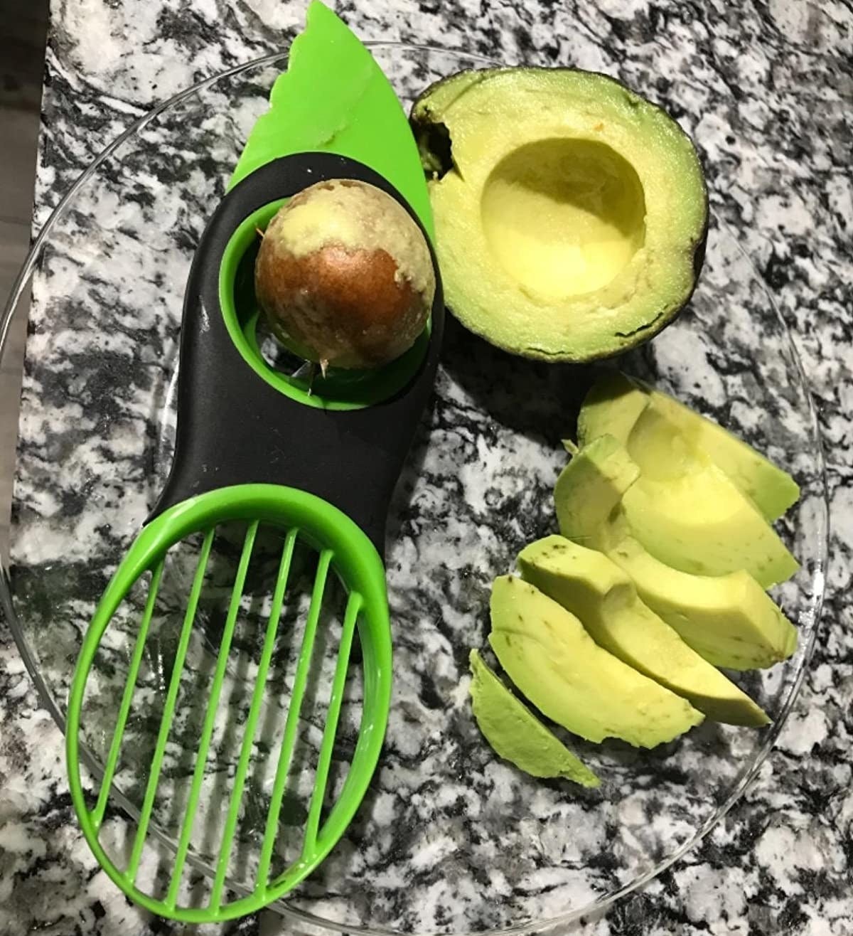 reviewer photo showing slicing tool next to slices of avocado on kitchen counter