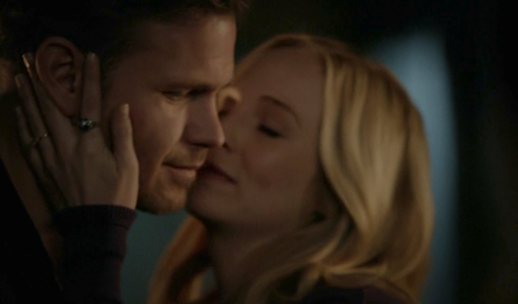 Caroline embraces Alaric warmly with hand across his cheek