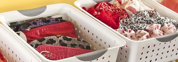 The plastic storage baskets being used to organized miscellaneous items in a closet.