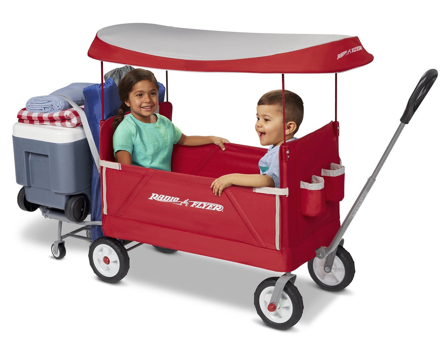 two children riding in a red radio flyer wagon