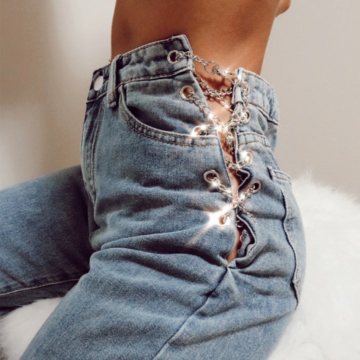 model wears chain detailed jeans