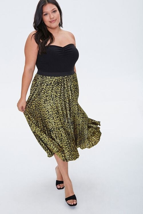 Model in olive leopard print midi skirt