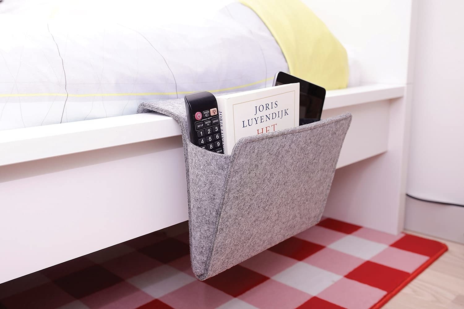 The bedside caddy positioned on the side of the bed