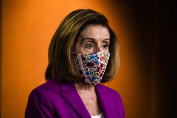 Pelosi wears a face mask as she speaks to the press