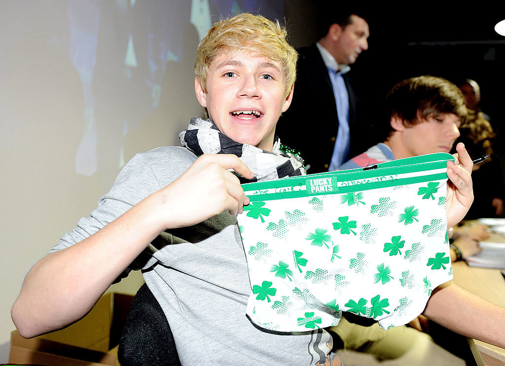 holding up a pair of boxers with braces