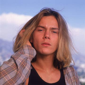 River Phoenix with long hair and wearing a flannel. It was the &#x27;90s after all.