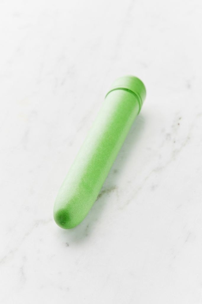 Green twist-bottom vibrator with a slightly tapered rounded top