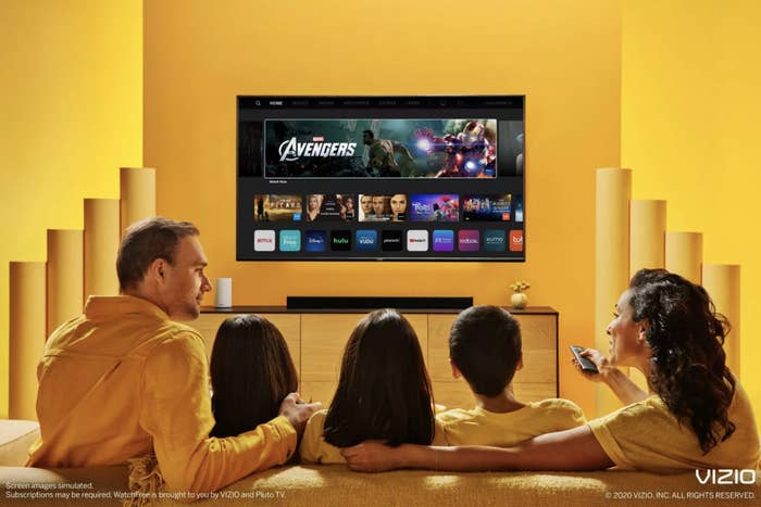 a family sitting around the tv