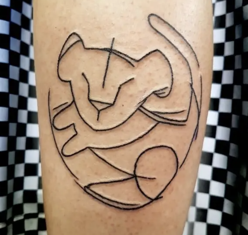 An arm tattoo of an outline of Young Simba from &quot;The Lion King&quot;