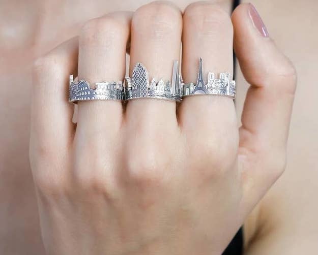 person wearing three cityscape rings