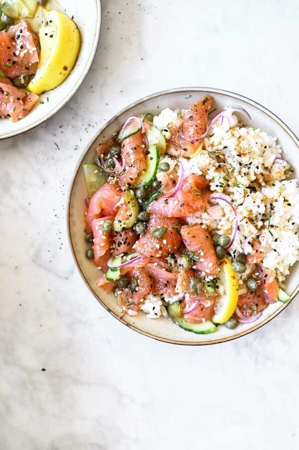 Salmon sashimi over rice with capers.