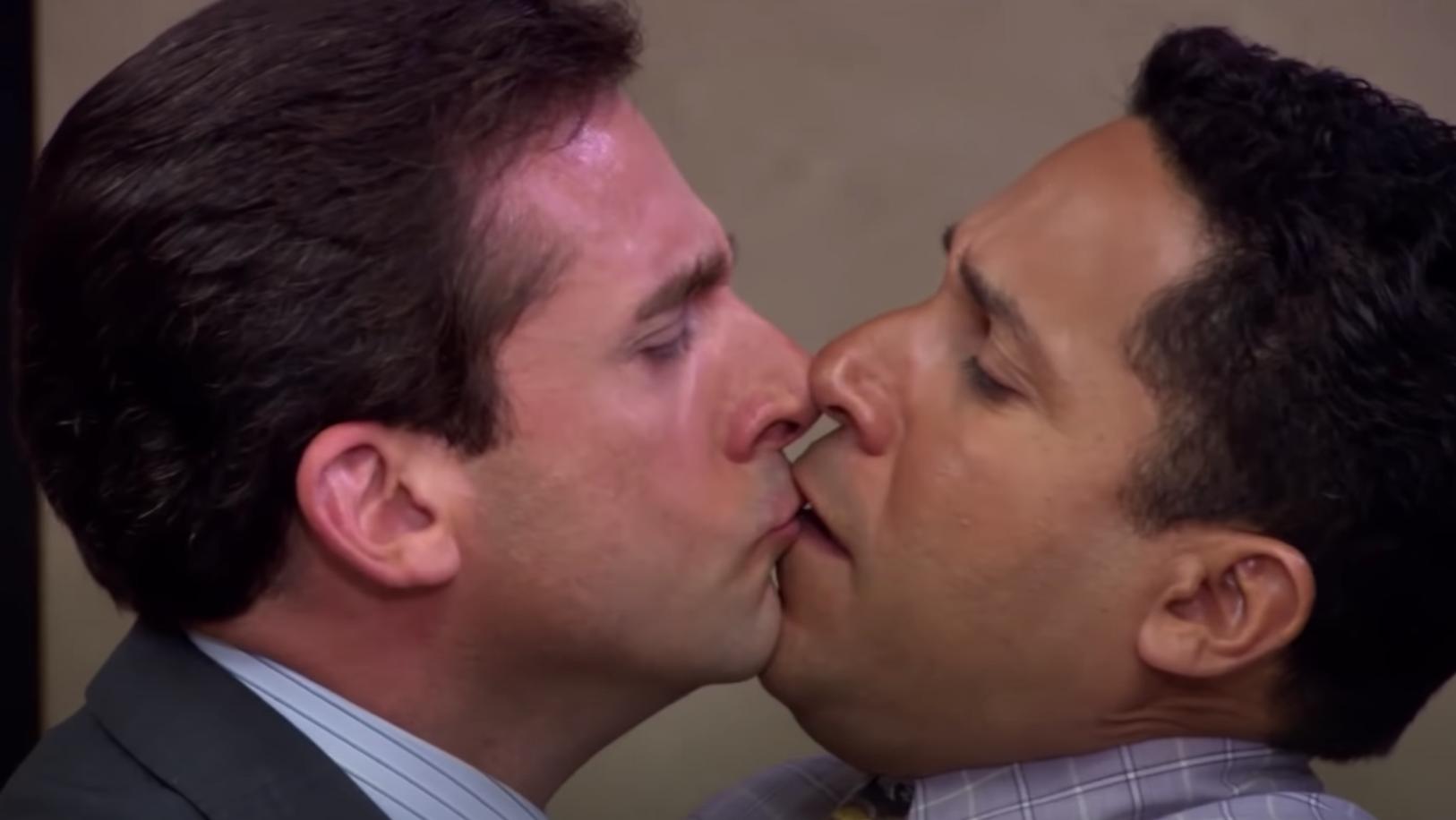Michael and Oscar awkwardly kissing