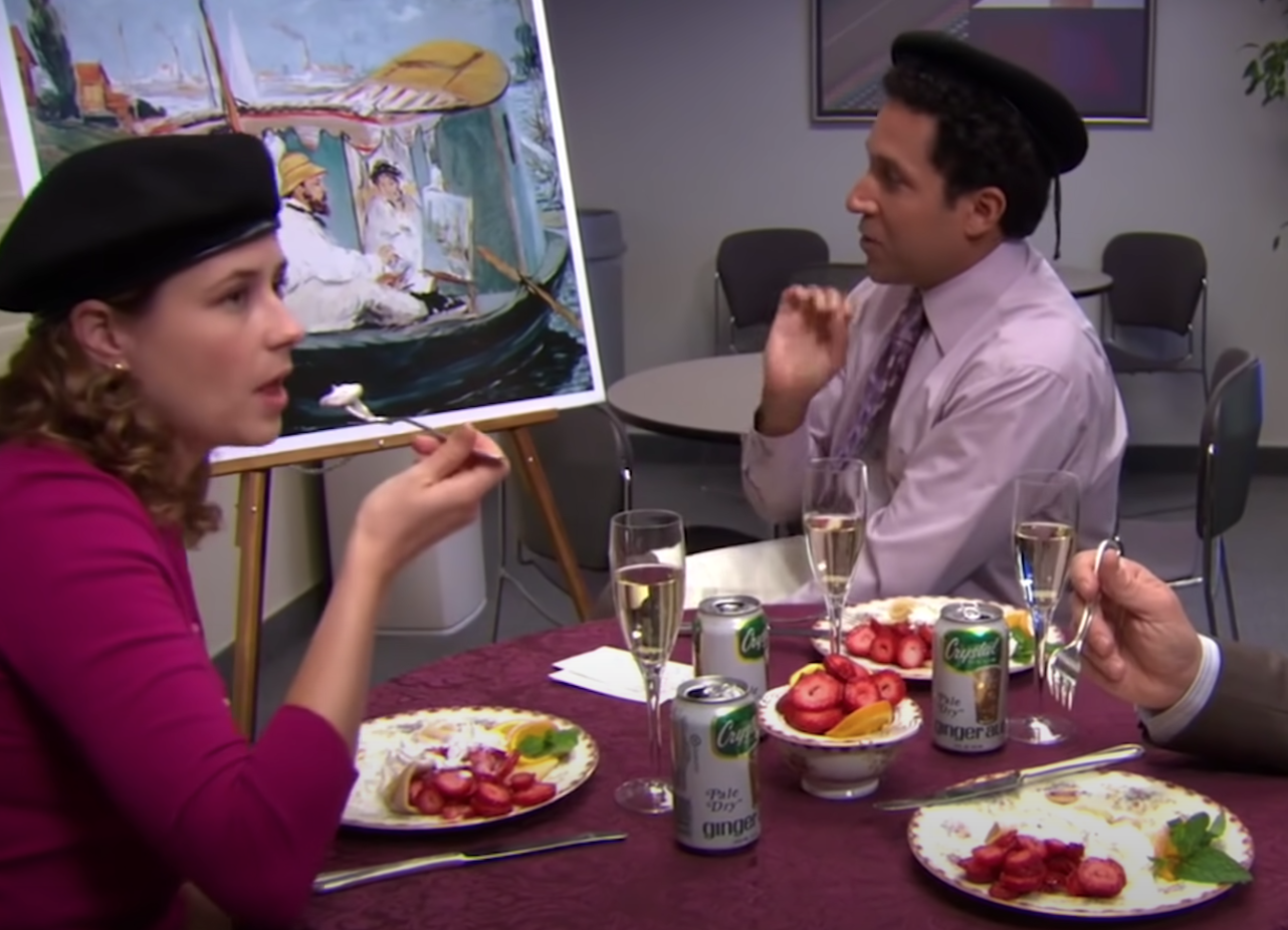 Oscar and Pam wearing berets and eating a fancy meal including ginger ale
