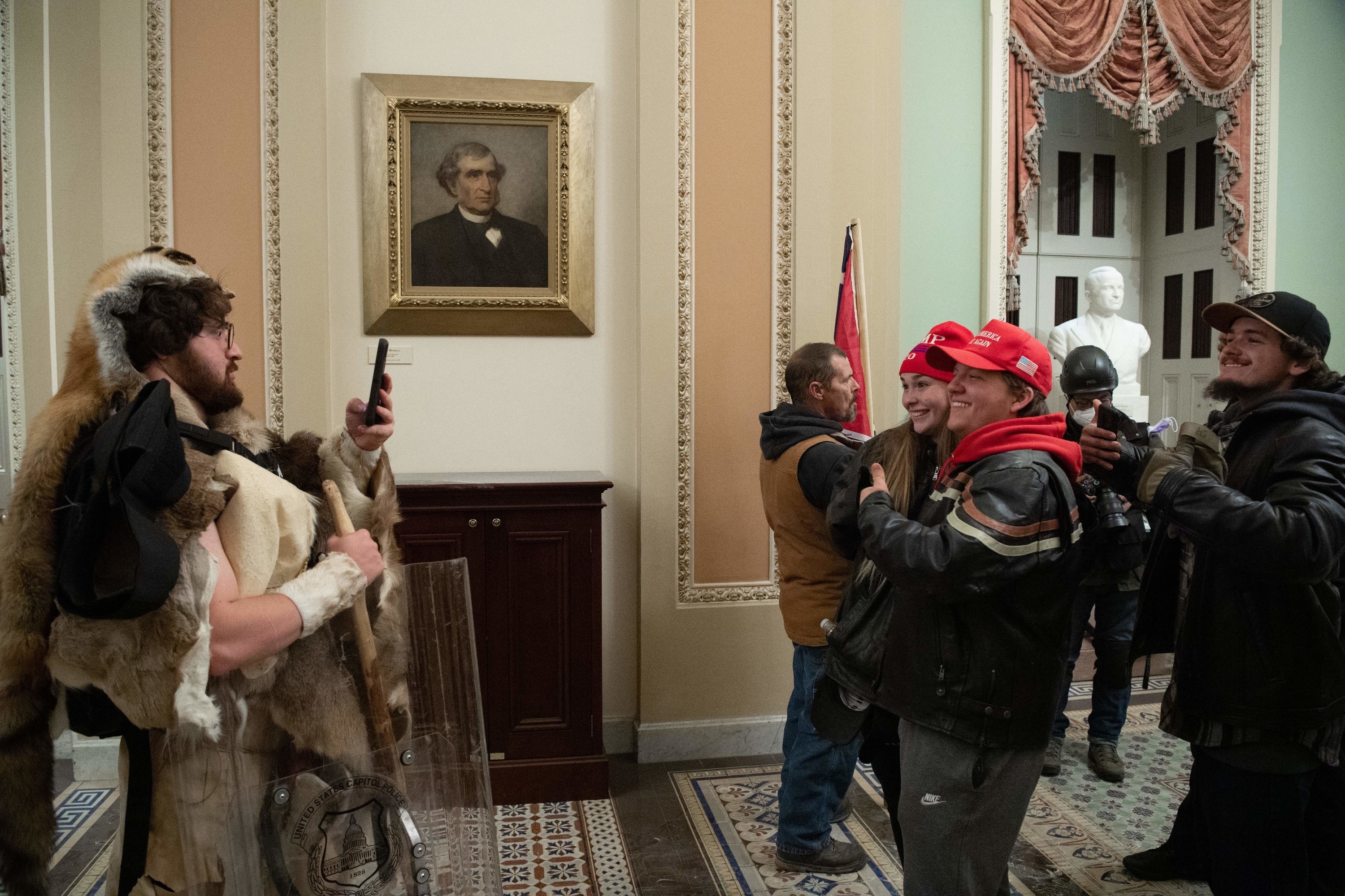 Trump supporters posing for a picture inside the Capitol