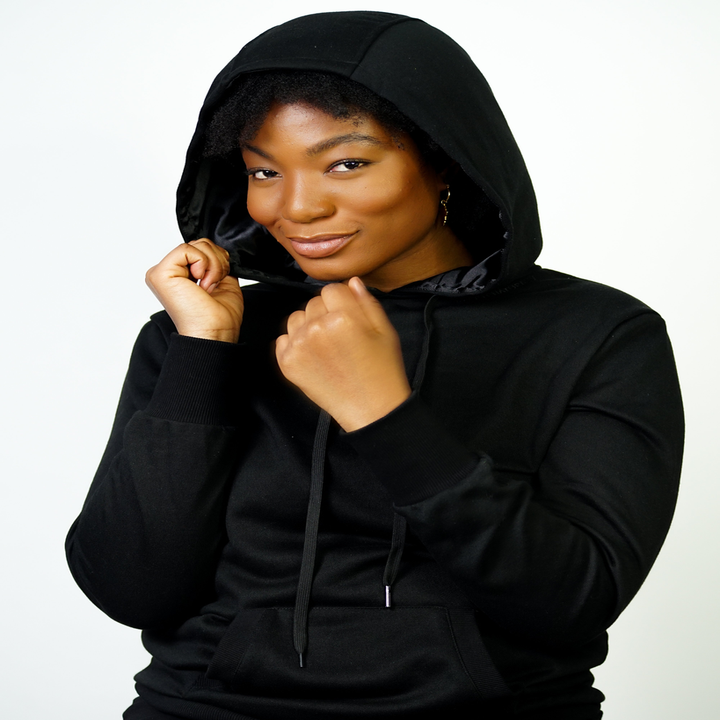 Model wearing black satin-lined Kin Apparel hoodie