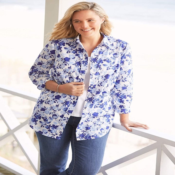 Model wearing button-down shirt with blue floral print