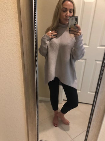 Amazon reviewer wearing gray turtleneck batwing sweater