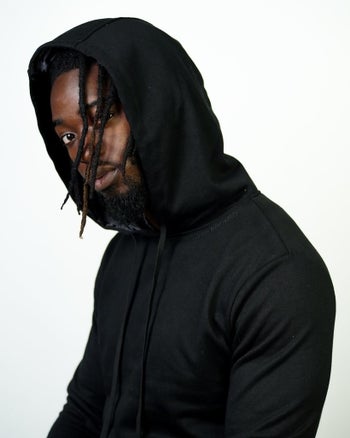 Model wearing black satin-lined Kin Apparel hoodie