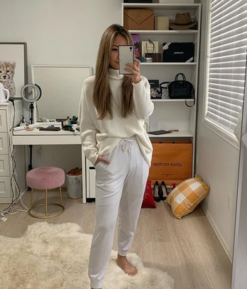 Amazon reviewer wearing white turtleneck batwing sweater