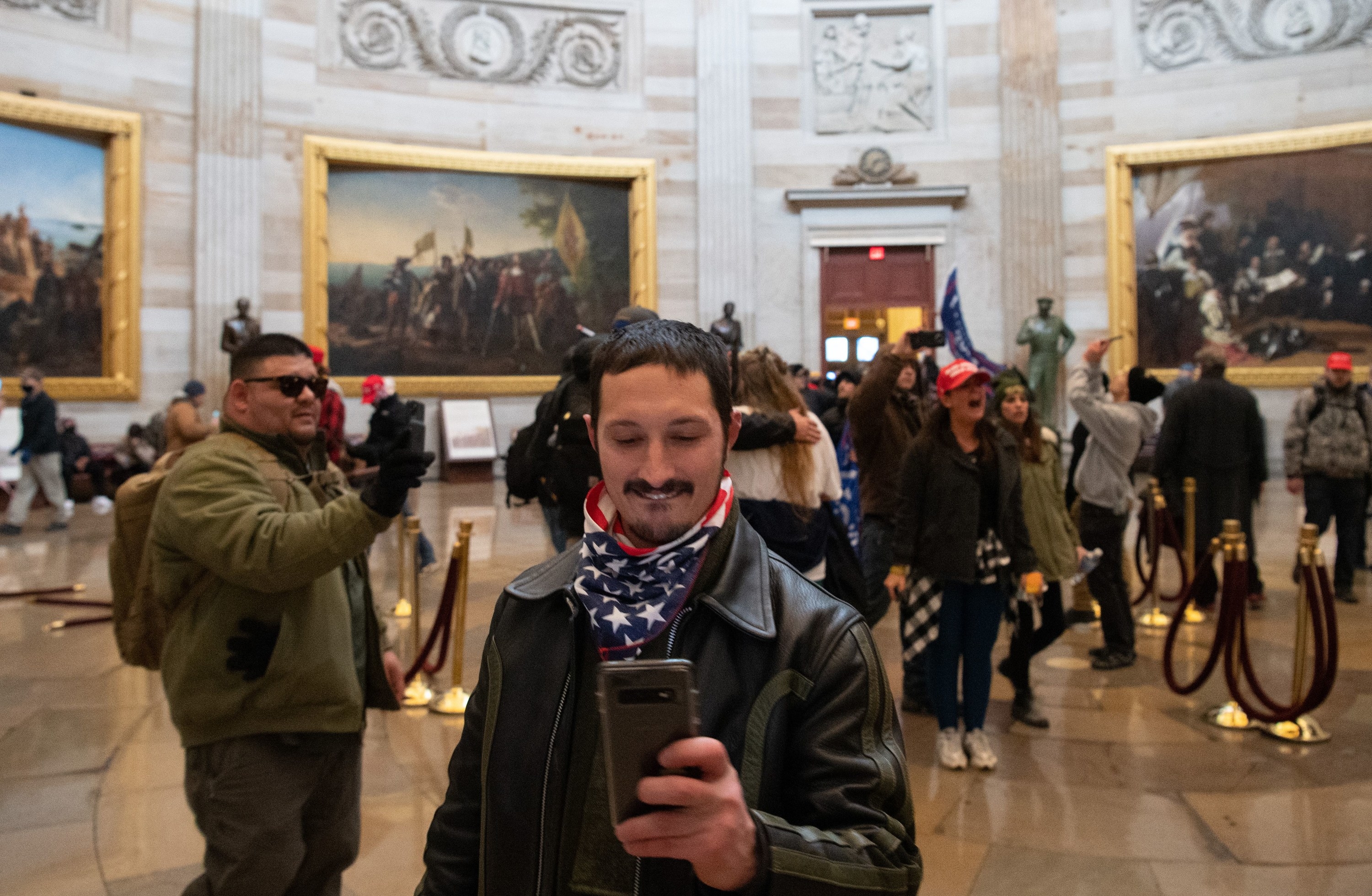 A Trump supporter taking a picture of the photo's photographer in the Capitol Rotunda