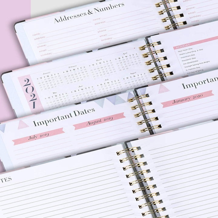 Four open notebooks showing the different address, calendar, important dates, and notes spreads 