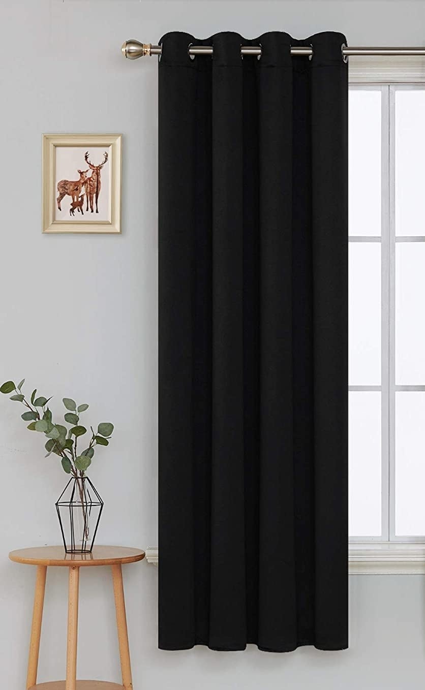 a panel of the curtain on a rod covering a window