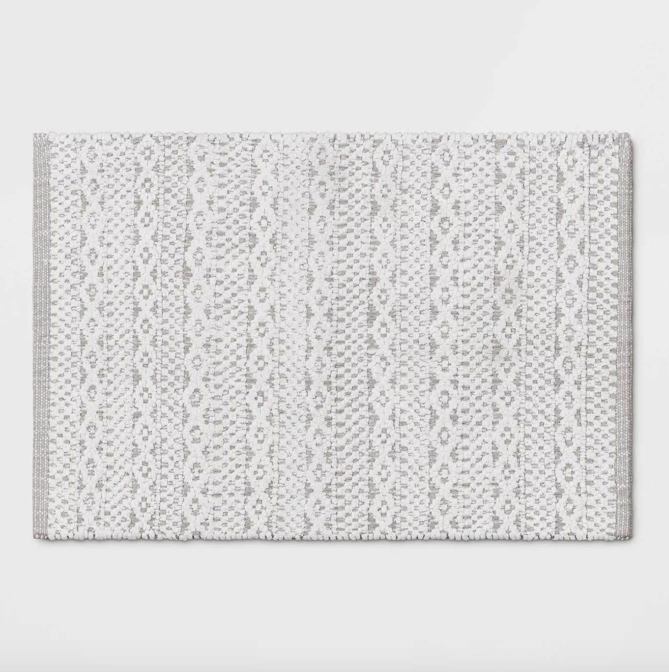 the rug in gray with a woven pattern in white 