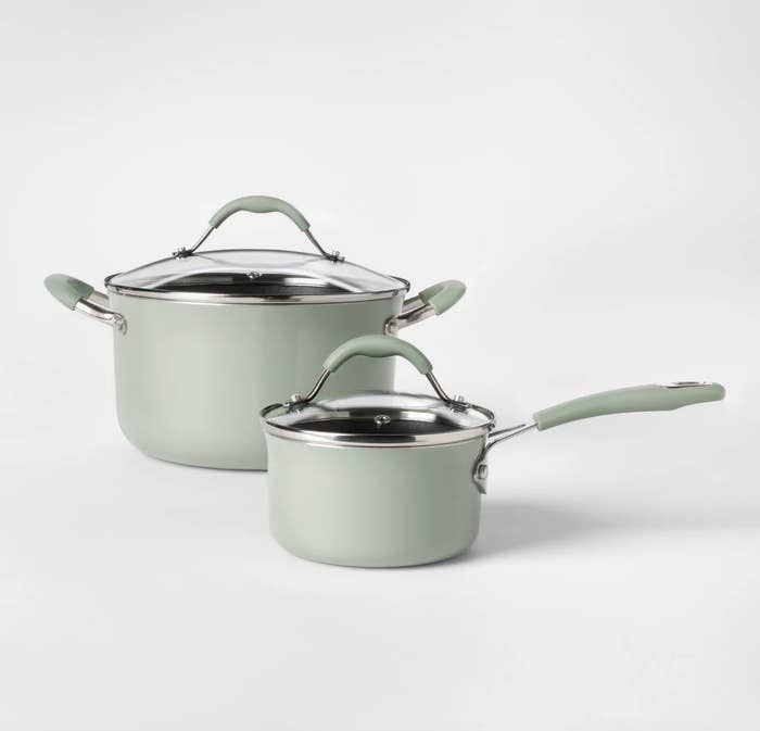the dutch oven and sauce pan with lids in mint green