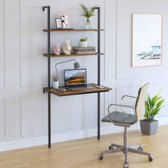The wall-mounted desk which has a work area and two shelves
