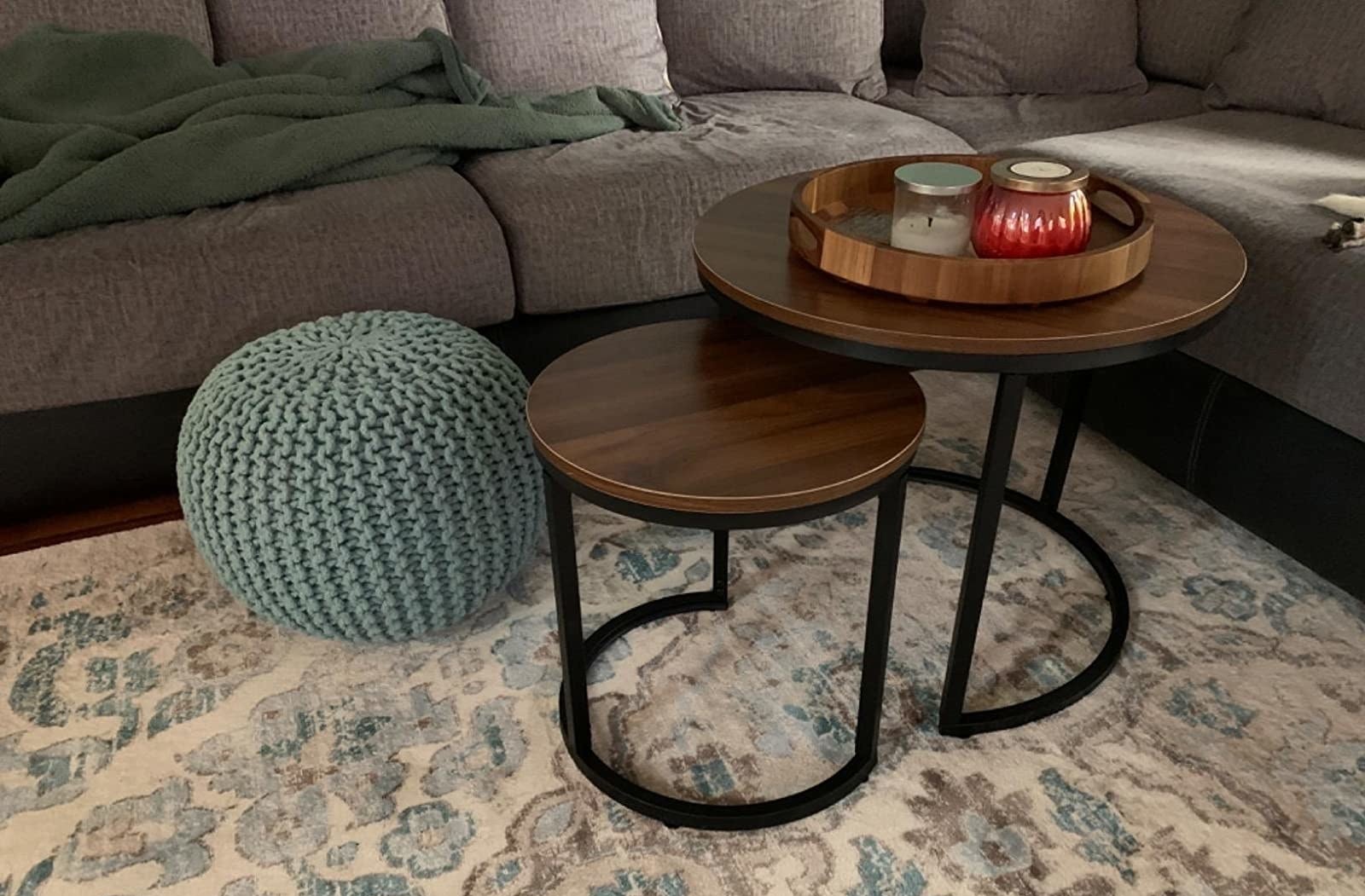 A reviewer&#x27;s photo of the circular nesting tables which have metal legs