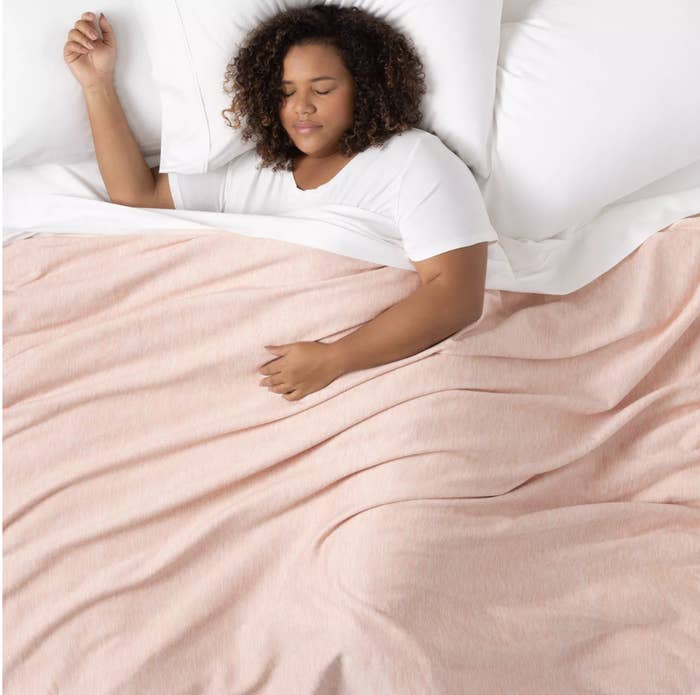 the blanket in pink draped over a person 