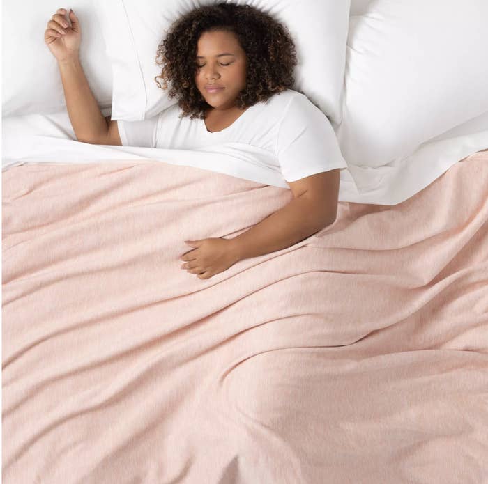 the blanket in pink draped over a person