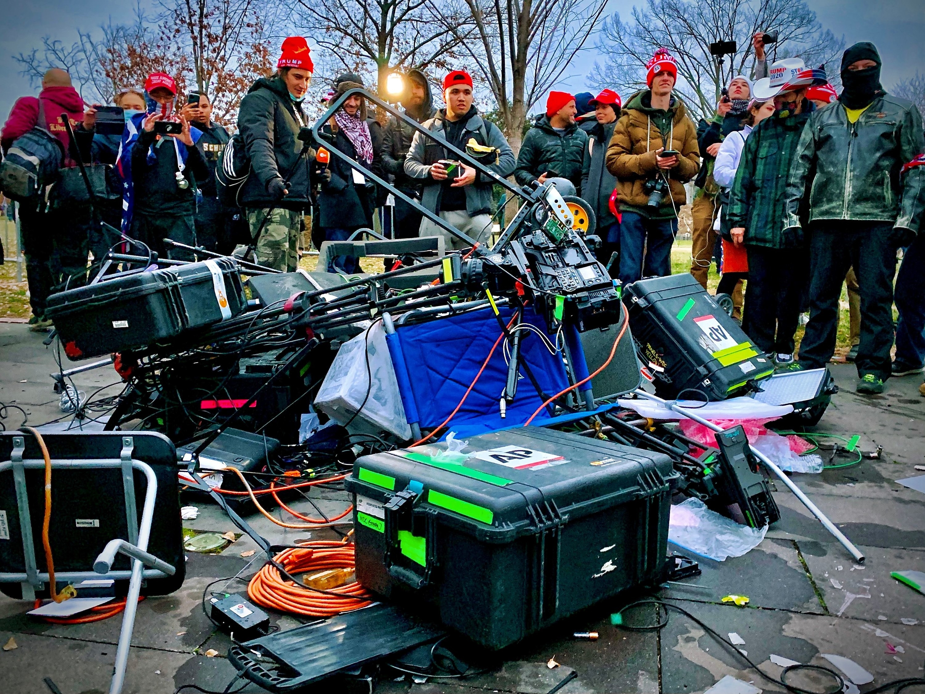  Supporters of US President Donald Trump stand next to media equipment they destroyed during their riot