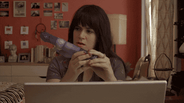 Abbi from &quot;Broad City&quot; looking at a big purple dildo