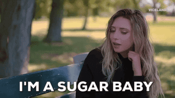 A girl sitting on a park bench and saying, &quot;I&#x27;m a sugar baby.&quot;