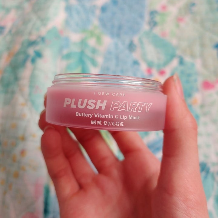 reviewer holding jar of lip balm