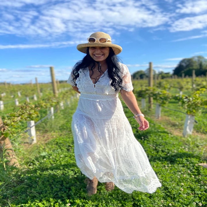 a reviewer in a field in the dress in white