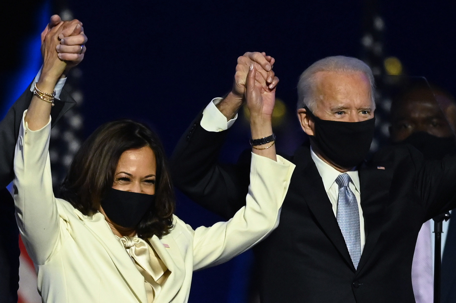 US President-elect Joe Biden and Vice President-elect Kamala Harris stand onstage after delivering remarks after being declared the winners of the presidential election