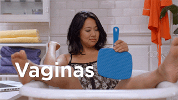 GIF of a person sitting in a bathtub with a mirror and looking at their vagina