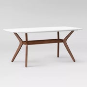 A table with white top and wooden legs in a modern style